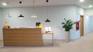 an office with a reception desk and a potted plant at Casas do Pastor in Seia +146 photos