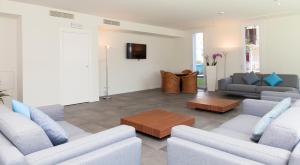 a living room with two couches and a tv at Residence Panama in Lido di Jesolo