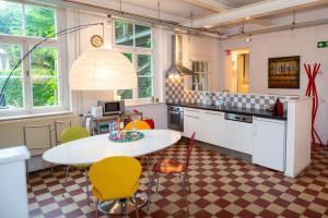 グルペンにあるDe Auw Sjoekelaatfabriekの部屋にテーブルと椅子のあるキッチン