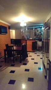 a dining room with a table and chairs and a kitchen at Славутич in Polyana