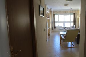 a room with a table and a chair and a dining room at Apartamento Centro Internacional in Algarrobo-Costa +30 photos