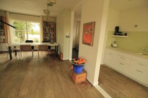 eine Küche und ein Esszimmer mit einem Tisch und einer Obstschale in der Unterkunft House Akerdijk 5 persons 3 bedrooms in Badhoevedorp
