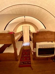 モランにあるBuffalo Valley Ranchの二段ベッド2台、暖房が備わる小さな客室です。