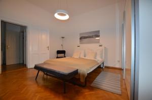 a bedroom with a bed and a chair in it at Apartment Penzing in Vienna