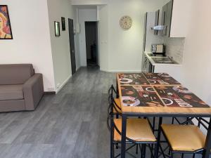 a kitchen with a table and chairs in a room at T2 - Quartier mythique du panier in Marseille