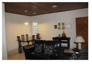 a living room with a couch and a table at Sítio Pousada Cio da Terra in Lumiar