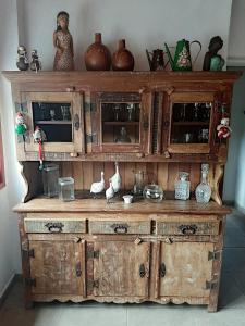 a large wooden cabinet with vases on top of it at Hospedaria e Hostel da Déia in Ouro Preto