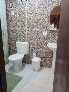 a bathroom with a toilet and a sink at Casa de Praia em Japaratinga-AL in Japaratinga