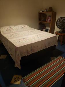 a bed in a room with a blanket on it at Casa de Praia em Japaratinga-AL in Japaratinga