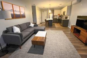 a living room with a couch and a coffee table at Luxury Apartment with Gym, Steps From Commuter Rail #3013 in Reading