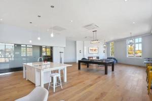 a kitchen and living room with a pool table at Luxury apartment with gym, steps from commuter rail #4011 in Reading