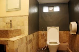 a bathroom with a toilet and a sink at ALA Hostel in Seminyak