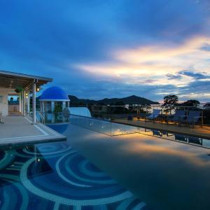 a view of a swimming pool at dusk at Costa Village Bangsaray in Bang Sare