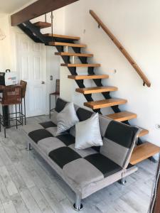 a living room with a black and white staircase at loft puerto varas in Puerto Varas