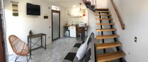 a living room with a staircase and a kitchen at loft puerto varas in Puerto Varas