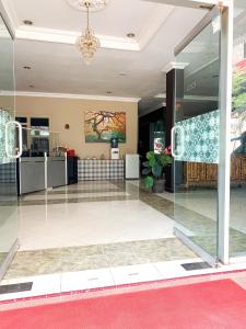 a lobby of a building with a glass door at Central City Hotel in Perabumulih