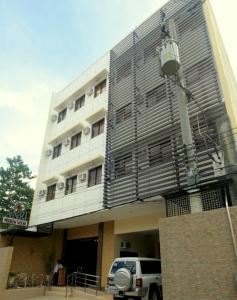 a building with a car parked in front of it at Anri Pension House in Cebu City