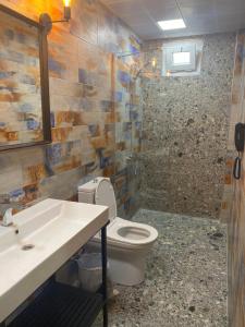 a bathroom with a toilet and a sink and a shower at OFURO WORLD HOTEL SPA in İzmir +25 photos