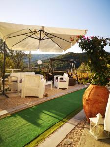 a garden with an umbrella and a green lawn at Villa Rosa in Agropoli +38 photos