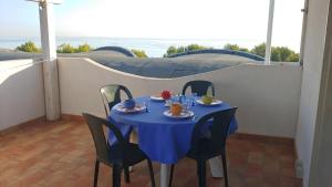 a table with a blue table cloth and chairs on a balcony at Marina di VASTO in Vasto