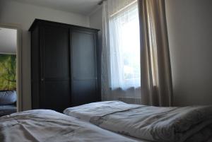 a bedroom with a bed and a window at Pension Leprich in Bad Goisern