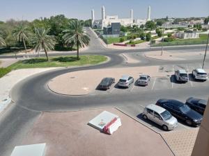 a street with cars parked in a parking lot at Al Massa Hotel in Al Ain