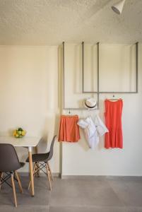 a dining room with a table and chairs and red skirts at Dream Village in Hersonissos