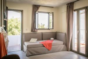 a living room with a couch with a laptop on it at Dream Village in Hersonissos