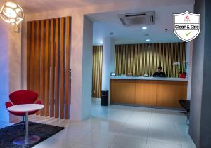 a man sitting at a counter in a hotel lobby at M Hotel in Jakarta