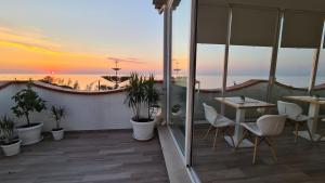 a balcony overlooking a beach with a view of the ocean at Pantanello Rooms Avola in Avola