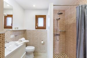 a bathroom with a toilet and a shower at Casa Can Picarola in Santanyi +18 photos