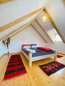 a bedroom with a bed in a attic at Balabani Local Stay in Podgorica