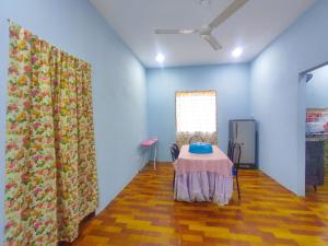 a room with a table and a window and a curtain at Teratak Aqish, Besut Terengganu in Kampong Gong Pauh
