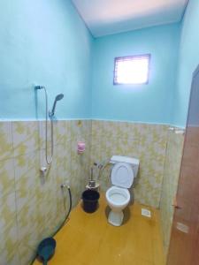 a bathroom with a shower and a toilet in a room at Teratak Aqish, Besut Terengganu in Kampong Gong Pauh