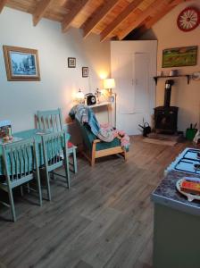 a living room with a table and chairs and a stove at Pat Tadys in Manorhamilton