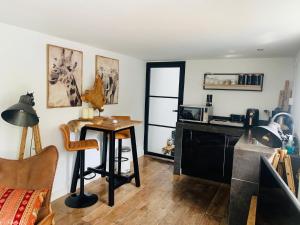 a living room with a table and a microwave at Finch guesthouse in Zandvoort