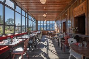 a restaurant with tables and chairs and windows at Refuge du Montenvers in Chamonix