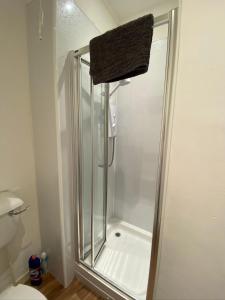 a shower with a glass door in a bathroom at Stylish 2nd Floor Georgian Period Flat in Dumfries