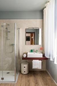 a bathroom with a sink and a shower at San Leonardo Suites in Verona
