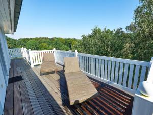 two benches sitting on the deck of a house at Villa Granitz - Apt. 09 in Binz