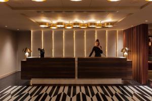 a woman standing in front of a counter in a salon at The Lynx Mountain Resort in Florina