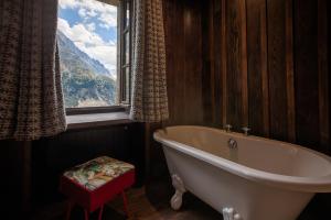 a bath tub in a bathroom with a window at Refuge du Montenvers in Chamonix