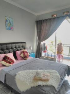 Postel nebo postele na pokoji v ubytování Syariah Runia villa