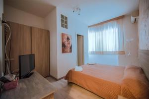 Postel nebo postele na pokoji v ubytování Hotel Sabatino
