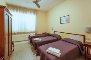 Postel nebo postele na pokoji v ubytování Hotel Sabatino