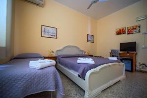 Postel nebo postele na pokoji v ubytování Hotel Sabatino