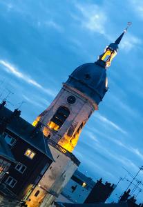 a tall tower with a clock on top of it at "LE COCON" en HYPERCENTRE PARKING GRATUIT in Amiens