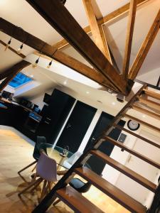 a loft with wooden beams and a glass table at "LE COCON" en HYPERCENTRE PARKING GRATUIT in Amiens
