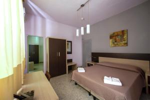 Postel nebo postele na pokoji v ubytování Hotel Sabatino
