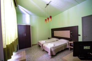 Postel nebo postele na pokoji v ubytování Hotel Sabatino